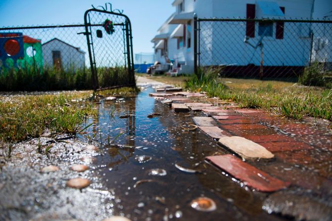 Sea water collects in front of a home in Tangier, Virginia, in May 2017. Tangier Island in Chesapeake Bay has lost two-thirds of its landmass since 1850. Now, the 1.2 square mile island is suffering from floods and erosion and is slowly sinking. A <a href="index.php?page=&url=https%3A%2F%2Fwww.nature.com%2Farticles%2Fsrep17890" target="_blank" target="_blank">paper</a> published in the journal Scientific Reports states that "the citizens of Tangier may become among the first climate change refugees in the continental USA."