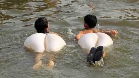 Boys swim in a stream during a heatwave in Islamabad, Pakistan, on Monday, June 5.