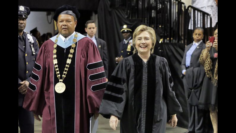Former Secretary of State Hillary Clinton arrives for the Medgar Evers College commencement with Dr. Rudolph Crew, president of the college, in Brooklyn, New York, on Thursday, June 8. Clinton delivered the commencement address. 
