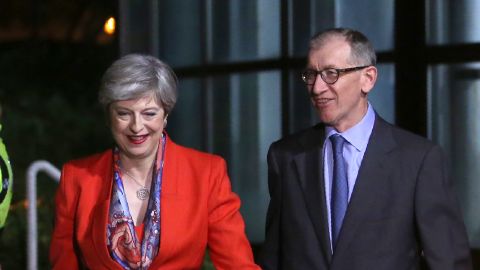British Prime Minister Theresa May, left, arrives with her husband Philip  at the count centre in Maidenhead.