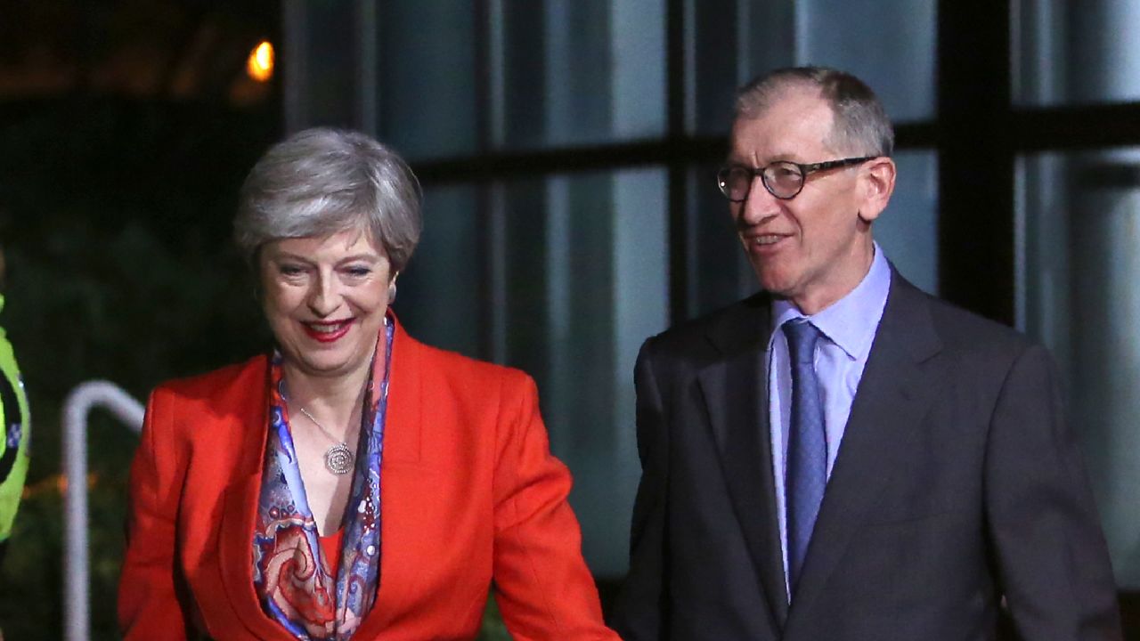 British Prime Minister Theresa May, left, arrives with her husband Philip at the count centre in Maidenhead.