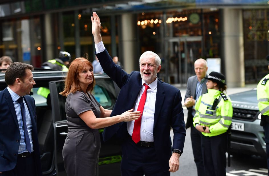 Labour Party leader Jeremy Corbyn greets a crowd as he arrives at Labour Party headquarters in London on June 9. Corbyn, who has called on May to resign, started his election campaign with a deficit in the polls of around 20 points. He ended it with more than 30 extra seats.