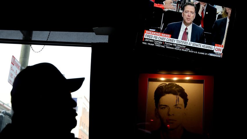 SAN FRANCISCO, CA - JUNE 08:  A patron at Ace's Bar watches a television broadcast of former FBI Director James Comey testify before the Senate Intelligence Committee on June 8, 2017 in San Francisco, California. People across the country are flocking to bars and restaurants to watch former FBI director as he testifies before the Senate Intelligence Committee about his conversations with U.S. President Donald Trump.  (Photo by Justin Sullivan/Getty Images)