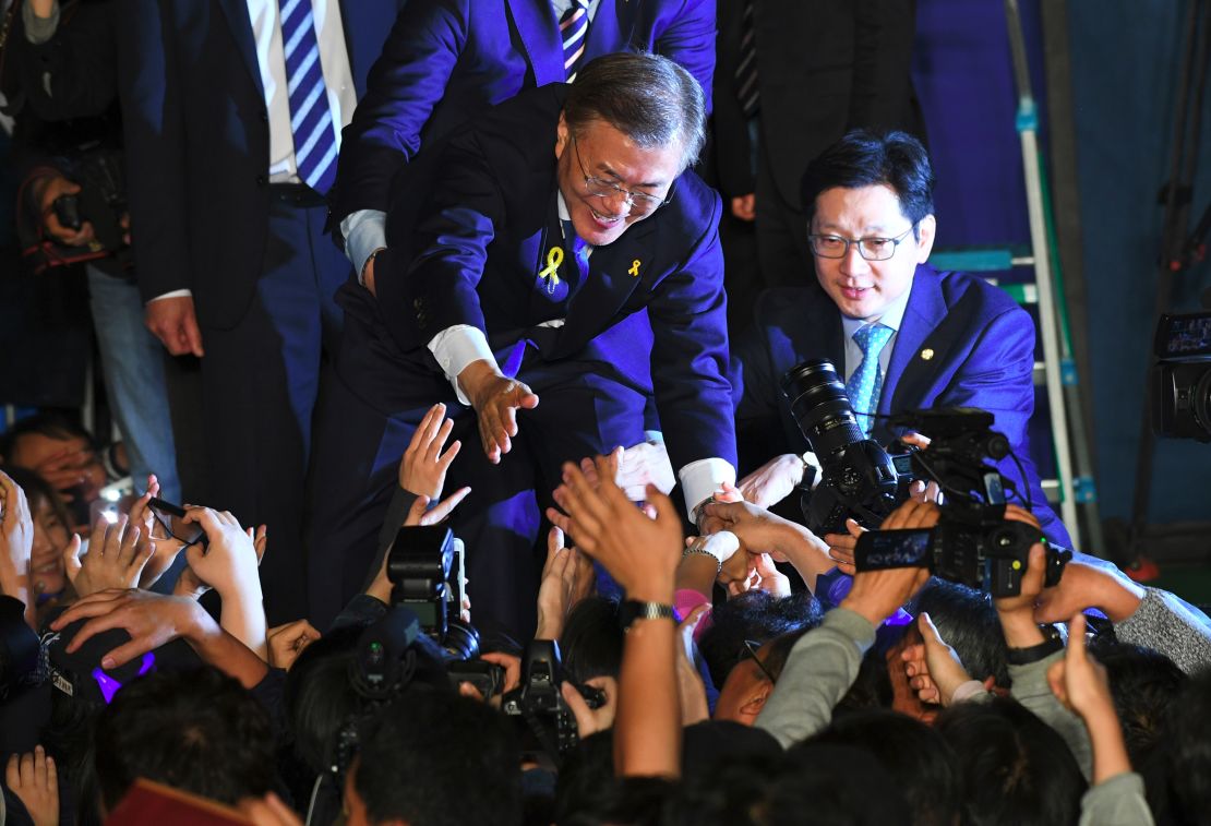 South Korean presidential candidate Moon Jae-in (C) of the Democratic Party greets his supporters.