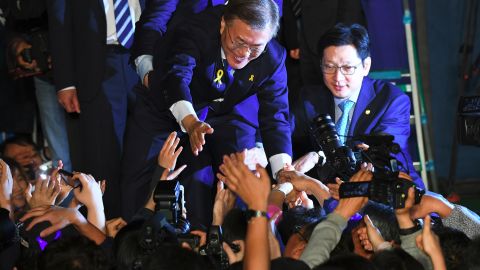 South Korean presidential candidate Moon Jae-in (C) of the Democratic Party greets his supporters.