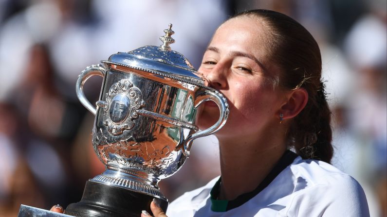 Jelena Ostapenko savors the Suzanne Lenglen trophy after winning the <a href="index.php?page=&url=http%3A%2F%2Fwww.cnn.com%2F2017%2F06%2F10%2Ftennis%2Ffrench-open-women-final-halep-ostapenko%2Findex.html">women's French Open</a> against Simona Halep in three sets 4-6, 6-4, 6-3 at Roland Garros stadium on June 10, in Paris.