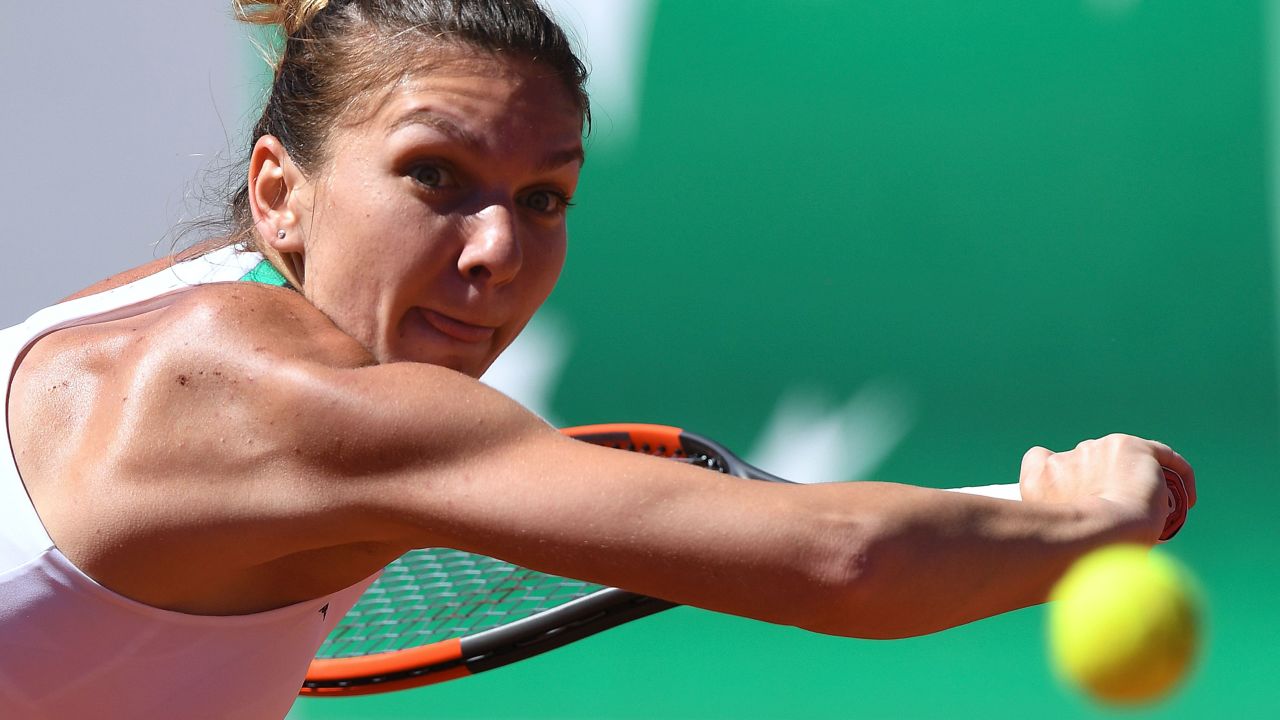 Simona Halep backhands the ball back to Ostapenko. The Romanian possesses a counter-punching game and against Ostapenko could do nothing but react to her opponent's booming ground strokes. 
