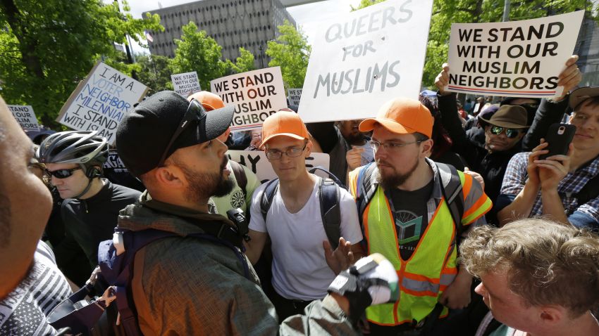 Opposing sides argue during an anti-Islamic law protest rally Saturday, June 10, 2017, in Seattle. (AP Photo/Ted S. Warren)