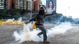 An opposition demonstrator throws a molotov cocktail in a clash with riot police during the "Towards Victory" protest against the government of Nicolas Maduro, in Caracas on June 10, 2017. Clashes at near daily protests by demonstrators calling for Maduro to quit have left 75 people dead since April 1, prosecutors say.