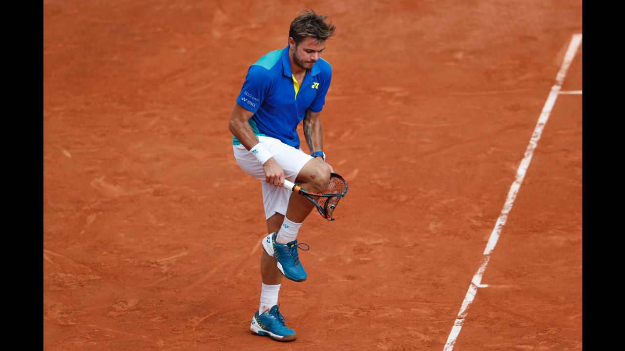 Wawrinka breaks his racket in frustration during his defeat by Nadal.