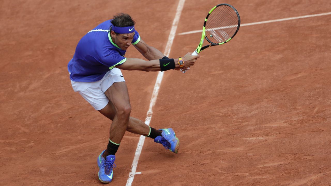 Nadal hits one of many returns during his  6-2 6-3 6-1 victory.