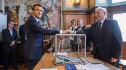 French President Emmanuel Macron (L) casts his ballot at a polling station to vote in the first round of the French legislative elections in Le Touquet, on June 11, 2017.  / AFP PHOTO / POOL / Christophe Petit Tesson        (Photo credit should read CHRISTOPHE PETIT TESSON/AFP/Getty Images)