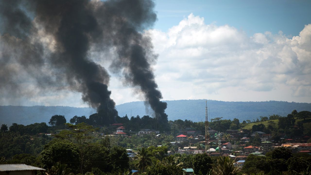 Smoke billows after air strikes by Philippine forces in Marawi City on Sunday.