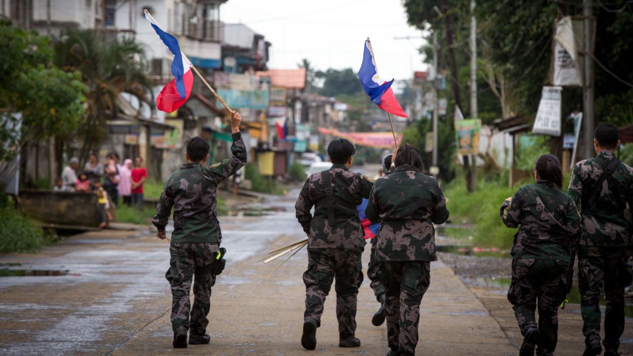 The Philippine National Police hang flags in war-torn Marawi City  to boost troop morale.