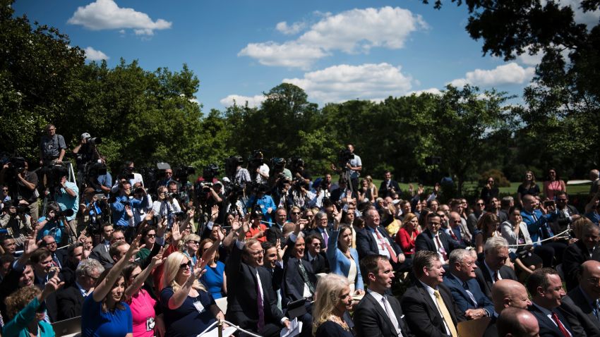 Reporters raise their hands to ask questions of US President Donald Trump and Romania's President Klaus Iohannis during a press conference in the Rose Garden of the White House June 9, 2017 in Washington, DC. / AFP PHOTO / Brendan Smialowski        (Photo credit should read BRENDAN SMIALOWSKI/AFP/Getty Images)