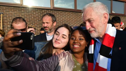 Labour Party leader Jeremy Corbyn takes a selfie photo with young supporters during a campaign event on May 10.