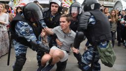 Russian police officers detain a participant of an unauthorized opposition rally in Tverskaya street in central Moscow on June 12, 2017. Over 200 people were detained on June 12, 2017 by police at opposition protests called by Kremlin critic Alexei Navalny, said a Russian NGO tracking arrests. "About 121 people were detained in Moscow up to this point. In Saint-Petersburg - 137," OVD-Info group, which operates a detention hotline, wrote on Twitter. / AFP PHOTO / STR        (Photo credit should read STR/AFP/Getty Images)
