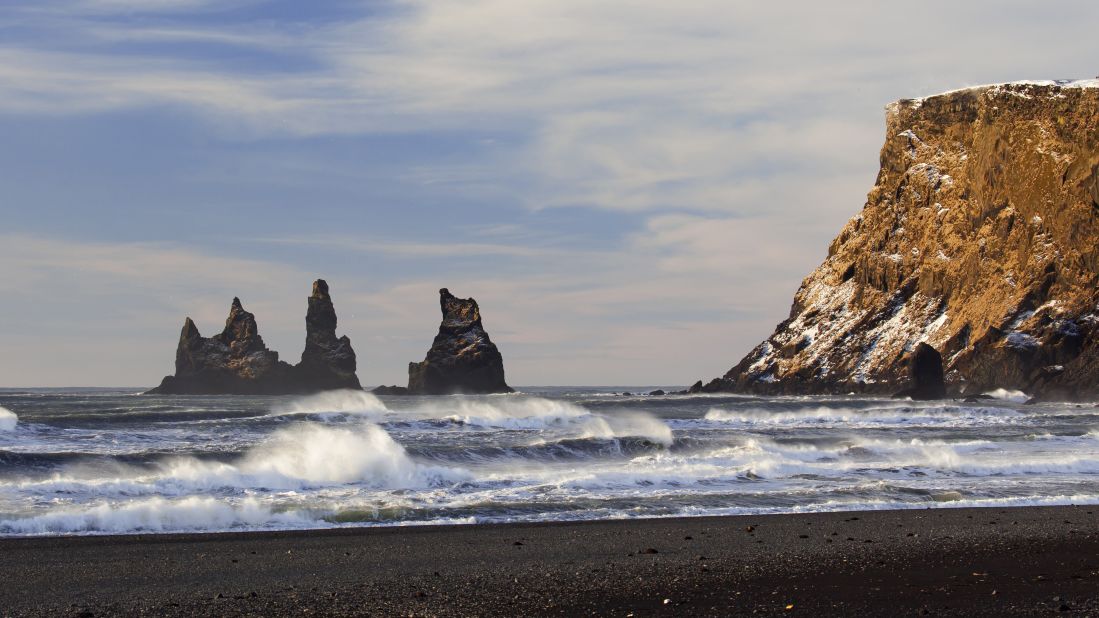 <strong>Reynisdrangar -- </strong>These striking basalt sea stacks jut out from a stunning black-sand beach at the foot of the Reynisfjall mountain in southern Iceland.