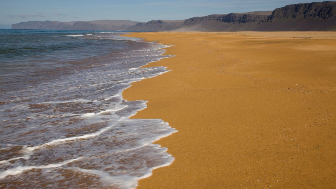 <strong>Rauðisandur beach</strong> -- This vast beach with golden-red sand lies in a remote area of the Westfjords and offers gorgeous views of the Látrabjarg area with the mighty Snæfellsjökull glacier looming in the background. 