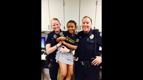 Rosalyn Baldwin, 7, with two police officers of Council Bluffs Police Department in Iowa.