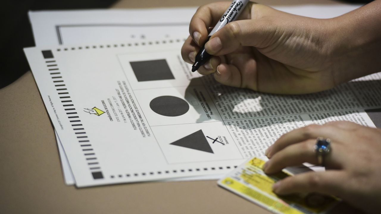 A Puerto Rican voter ticks a ballot during the fifth referendum in San Juan, Puerto Rico.
