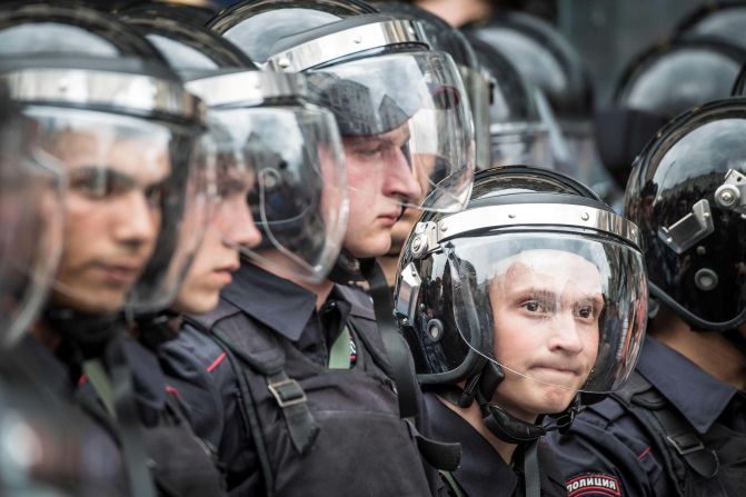 A line of riot policemen block the entrance to Tverskaya street as an unauthorized opposition rally takes place in central Moscow.
