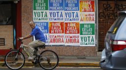 A rides his bicycle in front of a wall covered with campaign posters promoting Puerto Ricos statehood in San Juan, on June 9, 2017.
A referendum on the political status of the US territory takes place on June 11, 2017. The US commonwealth of Puerto Rico votes on whether to become the 51st state.