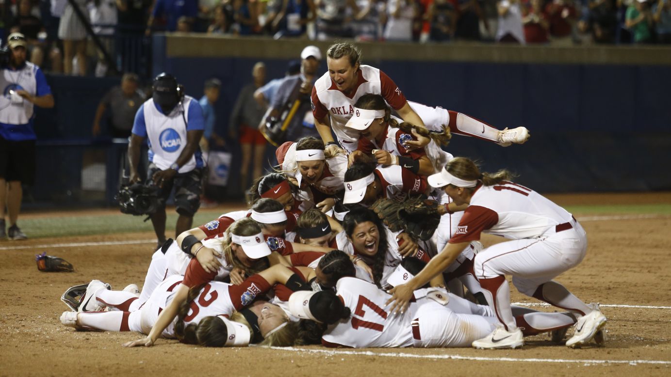 Oklahoma softball players jump in a pile after winning the NCAA title on Tuesday, June 6. They also won the championship last season.