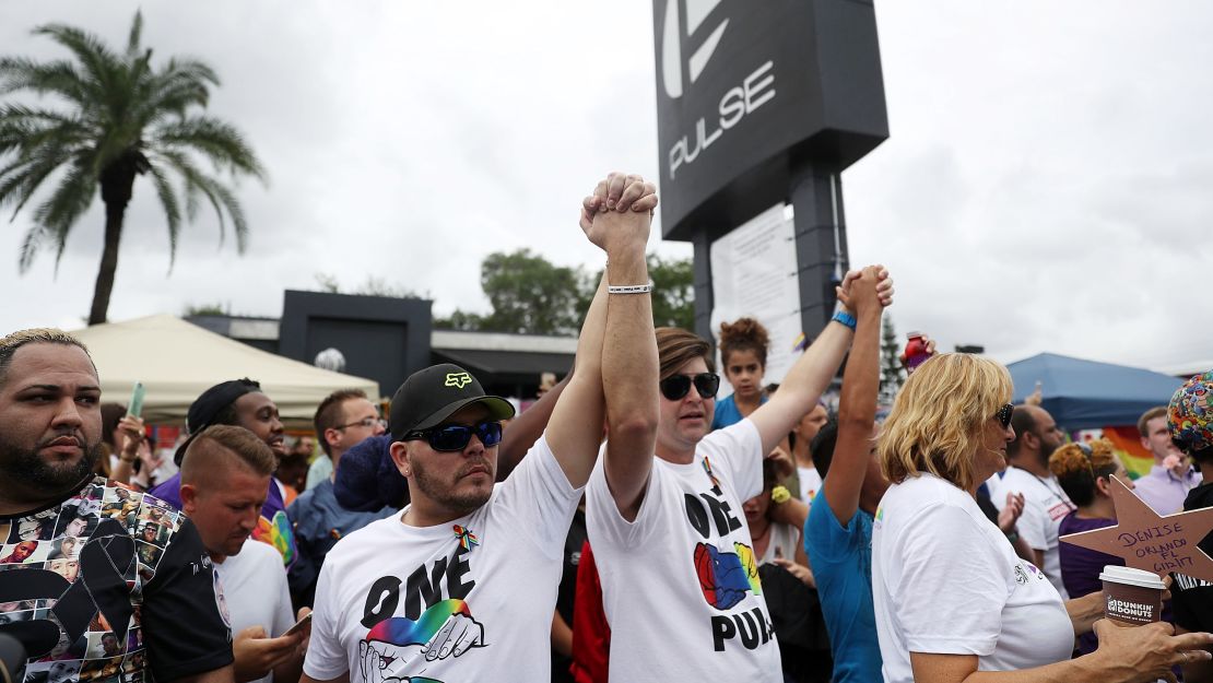 People mark the one-year anniversary of the Pulse nightclub shooting on June 12, 2017 in Orlando, Florida.