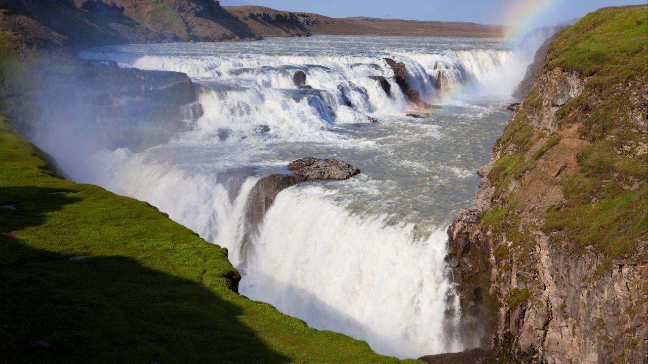 <strong>Gullfoss --</strong> The towering waterfall cascades 32 meters in two stages with whitewater tumbling over basalt rocks amid a lush green backdrop in the summer, or stark white snow in the winter months.