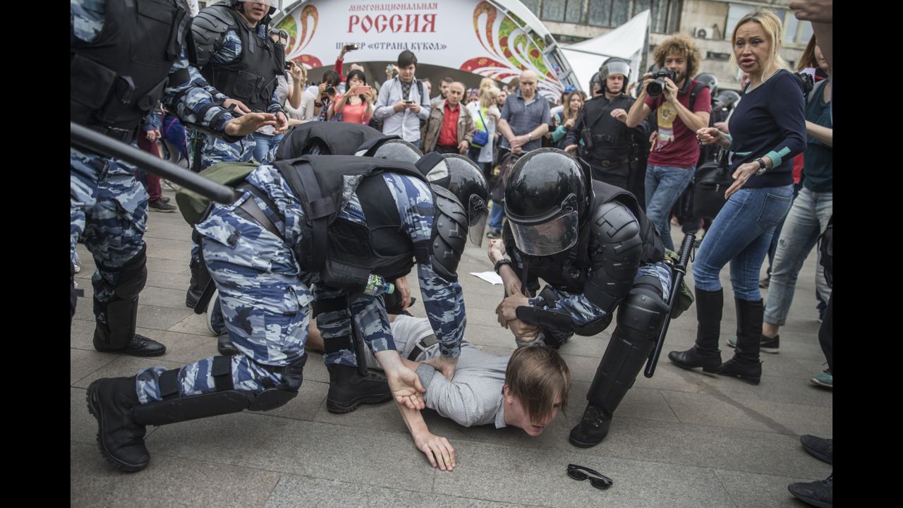 Police detain a protester In Moscow, Russia, Monday, June 12, 2017.