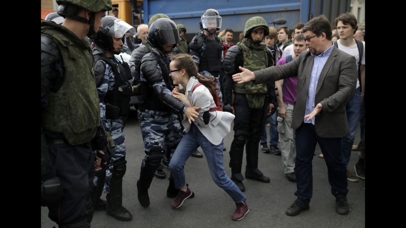 A young girl reacts as her friend is detained by police during a demonstration in downtown Moscow.