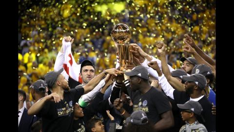 The Golden State Warriors celebrate with the Larry O'Brien Championship Trophy after winning Game 5 of the NBA Finals on Monday, June 12. Golden State won 129-120 to collect its second title in three years.