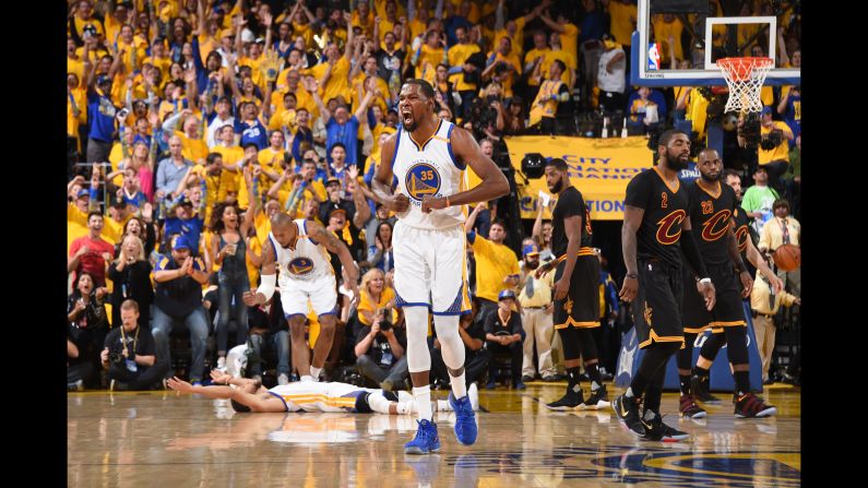The Golden State Warriors, led by Kevin Durant at center, celebrate during Game 5 of the NBA Finals on Monday, June 12. <a href="index.php?page=&url=http%3A%2F%2Fwww.cnn.com%2F2017%2F06%2F12%2Fus%2F2017-nba-finals-game-5-cavaliers-warriors%2Findex.html" target="_blank">Golden State won 129-120</a> to collect its second title in three years. It was the first title for Durant, who signed with the Warriors before this season. Durant was named the Finals' Most Valuable Player, scoring at least 31 points in all five games.