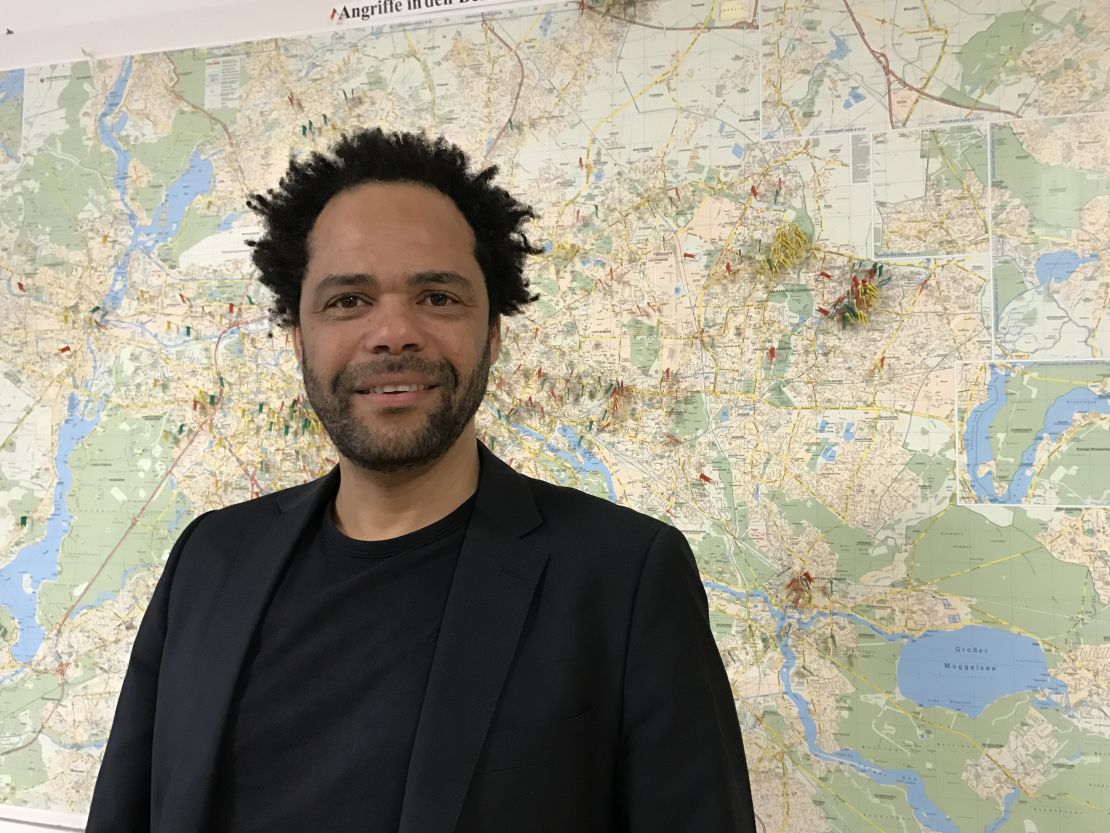 Eben Louw, a psychologist at an anti-violence aid group in Berlin. The map behind him shows all the attacks on refugees and migrants recorded in the city. "What is new is the level of brazenness."
