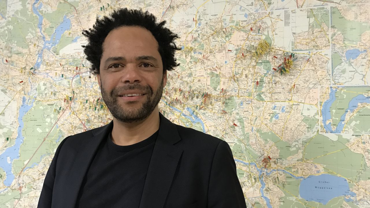 Eben Louw, a psychologist at an anti-violence aid group in Berlin. The map behind him shows all the attacks on refugees and migrants recorded in the city. "What is new is the level of brazenness."