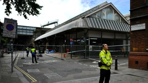 A security guard stands at a cordon at an entrance to Borough Market on Sunday. 