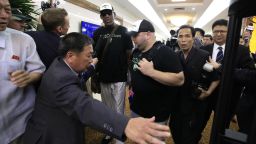 Former NBA basketball star Dennis Rodman is surrounded by North Korean officials and photographers upon his arrival at Sunan International Airport on Tuesday, June 13, 2017, in Pyongyang, North Korea. (AP Photo/Kim Kwang Hyon)