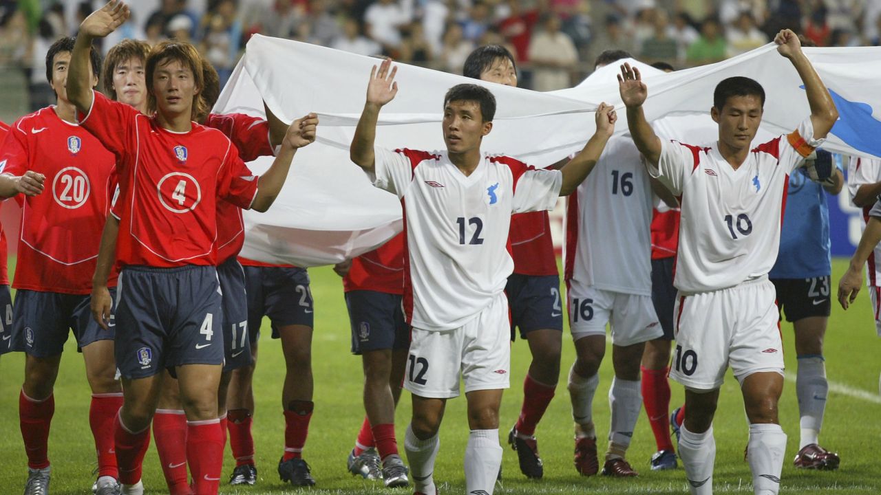 South and North Korean players wave to the crowd after a friendly match between the two countries in 2005.
