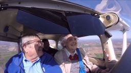 Mildred "Milly" Reeves, right, flies a Cessna Model 172 with assistance from pilot Pete Lockner, left. (Screengrab of family video/YouTube) 