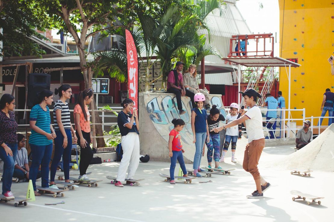 During a workshop, Verghese teaches kids how to skateboard.