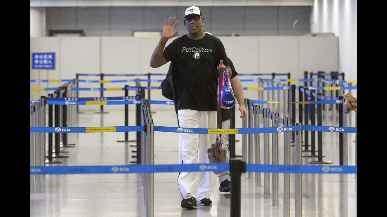 Rodman waves to photographers at Beijing Capital International Airport ahead of his departure to Pyongyang on June 13.