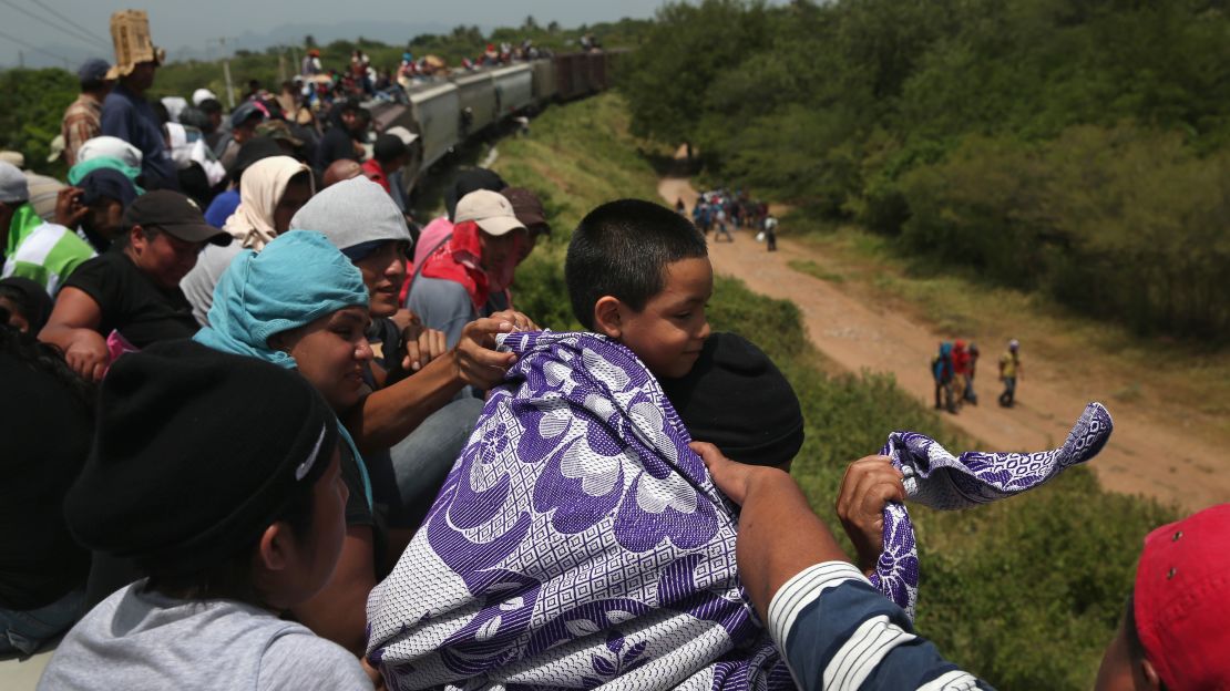 Migrants take a dangerous ride on a freight train in August 2013, in Ixtepec, Mexico. The number making the journey from Central America to the US has dipped since President Trump's election. 