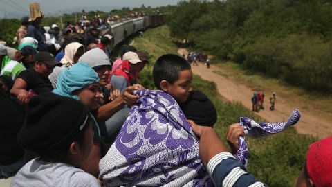 Migrants take a dangerous ride on a freight train in August 2013, in Ixtepec, Mexico. The number making the journey from Central America to the US has dipped since President Trump's election. 