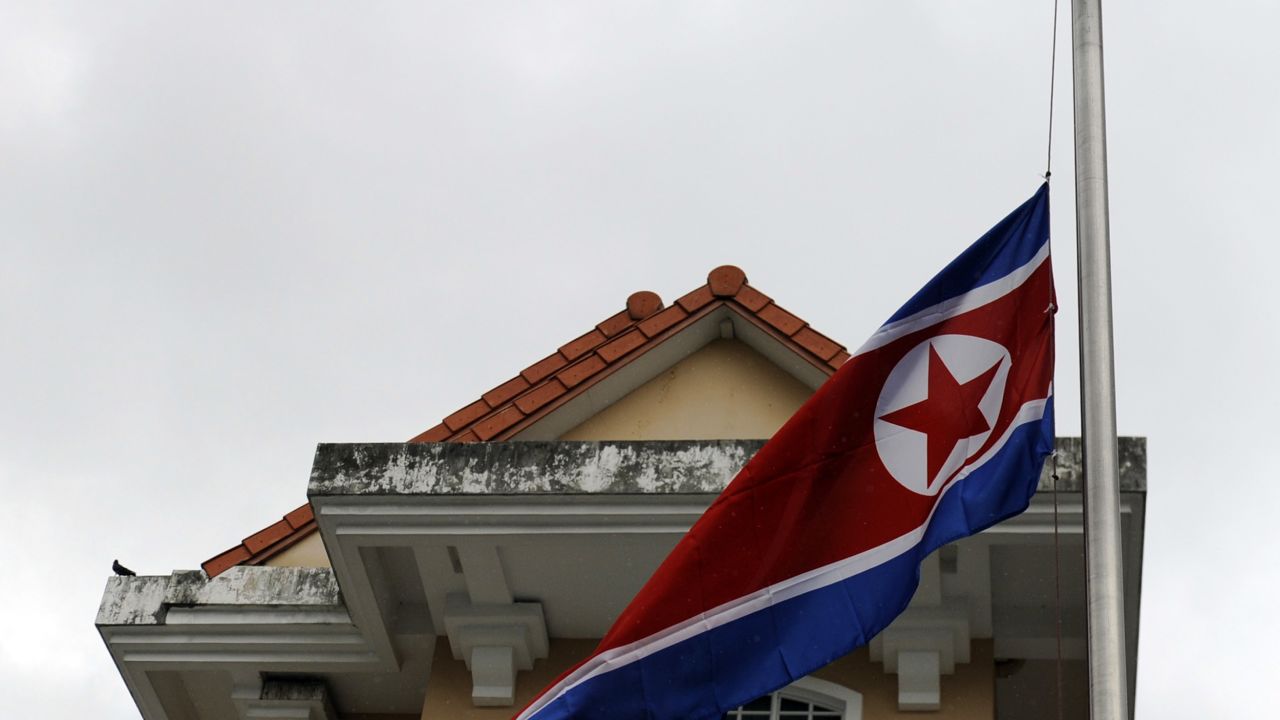 The North Korean national flag flutters at half mast at the North Korea embassy in Singapore on December 20, 2011. North Korean leader Kim Jong-Il has died aged 69 of a heart attack, state media announced, plunging the nuclear-armed and deeply isolated nation into a second dynastic succession. AFP PHOTO / SIMIN WANG (Photo credit should read SIMIN WANG/AFP/Getty Images)
