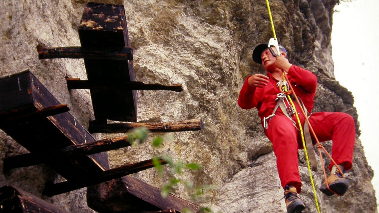 Rapelling down a cliff to get a look at the coffins.