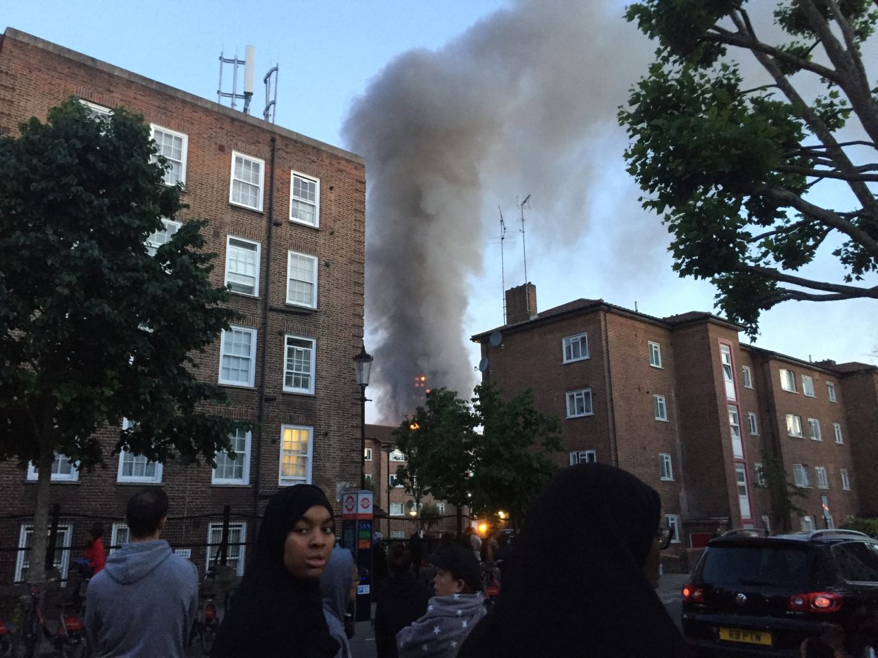 Smoke could be seen billowing over the heads of residents who gathered in nearby streets to watch the blaze.