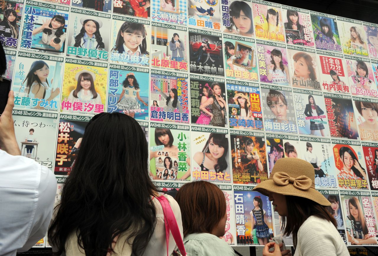 AKB48 fans watch the election campaign posters prior to the group's general election announcement in 2013.  