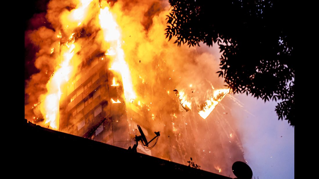 Burning debris falls from Grenfell Tower as a massive fire engulfs the London apartment building early on June 14, 2017. Seventy-two people are confirmed to have died in the fire.