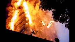 Burning debris falls at the scene of a huge fire at Grenfell Tower in White City, London Grenfell Tower fire, London, UK - 14 Jun 2017 The blaze engulfed the 27-storey building with 200 firefighters attending the scene. There were reports of people trapped in the building. (Rex Features via AP Images)